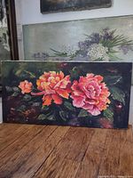 Front view of floral canvas painting showing colours, flowers, signature