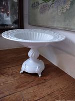 Overall view of white pierced pedestal fruit bowl showing bowl, rim, pedestal and base