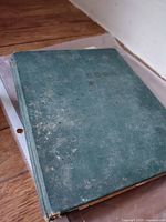 Worn green cloth recipe notebook closed