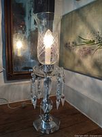 Lamp illuminated showing overall design, prisms and etched hurricane shade