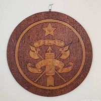 front view of round carved IOOF wooden plaque showing emblem details
