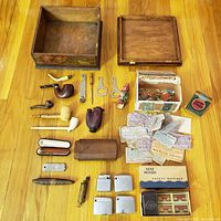 Entire lot laid out showing boxes, pipes, lighters, coupons, matchbooks