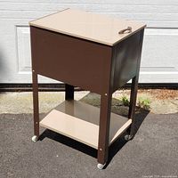 Three-quarter view of cart showing lift-top closed, casters, shelf, and paint finish