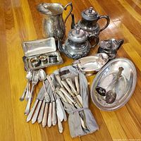 Group shot of all silverplate items on wooden floor