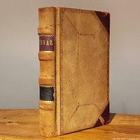 Front cover and spine of leather ledger journal standing upright
