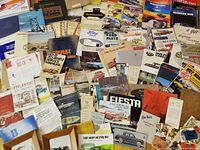 Wide shot of entire assortment spread on floor showing manuals, brochures, booklets