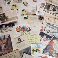 All postcards and greeting cards spread out showing fronts and illustrations
