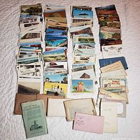 Full view of all postcard stacks and paper sleeves on quilt
