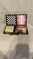 Case open showing boards, domino tiles, game pieces