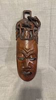 Front view of carved wooden wall mask