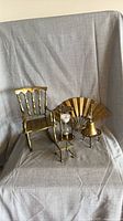 All five brass decorative items arranged together
