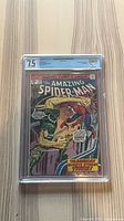 Front view of CGC-slabbed Amazing Spider-Man #154 comic showing grade and cover