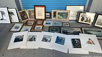 Entire collection laid out showing framed pieces and matted prints