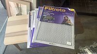 Stack of five Filtrete Healthy Living filters on table