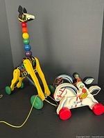 Both pull toys standing side by side showing size and design