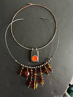 Both chokers laid flat to show overall form and relative size