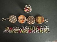 Overview of all three jewellery pieces: Barbie disc bracelet, Storm bead bracelet, enamel ring