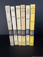 Spines of six Nancy Drew hardcover books showing titles and volume numbers