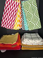 Stacks and hung examples of napkins and tea towels showing colours and patterns