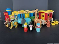 Full group shot showing locomotive, three cars, figures and animals