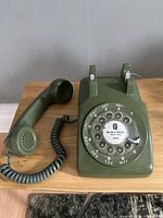 Telephone with handset off cradle showing body, handset and coiled cord