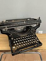 Front three-quarter view showing full keyboard, carriage, and branding