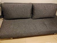 Front view of dark gray sofa bed with two back cushions