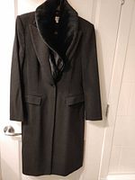 Front view of charcoal gray overcoat with black faux fur collar hanging