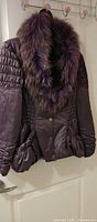 Front view of purple Mila Duo coat showing fur collar, ruched waist, snap buttons, gathered pockets