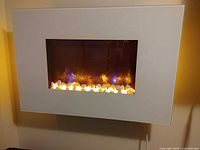 Wall-mounted SimpliFire electric fireplace showing product the remote controls