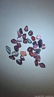 Group of multicolored spinel crystals on white background