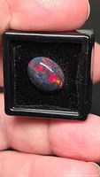 Opal in display case showing play-of-colour