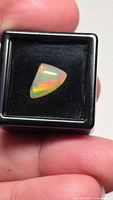Loose Ethiopian opal in display box showing play-of-color