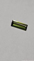 Top view of rectangular green tourmaline showing baguette cut
