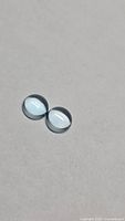 Matched pair of round sky blue topaz cabochons viewed from above