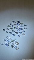 Top view of entire parcel of oval-cut tanzanite gemstones