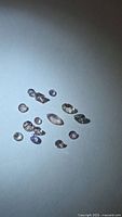 Group of loose pink tanzanite gemstones on blue background