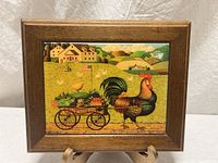 Full view of framed tile art on stand