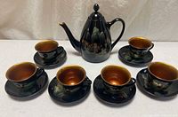 full set arranged: teapot, six cups on saucers