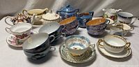 Group view of all cups, saucers, sugar bowls and creamer