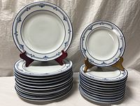 Full set of dinner and salad plates stacked, pattern visible