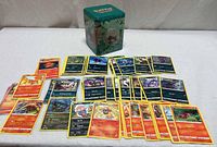 All cards laid out with storage tin behind