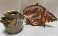 Jar and shell dish side by side
