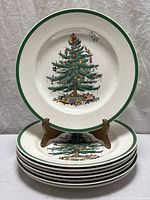 Stack of six Spode Christmas Tree dinner plates, one displayed on stand