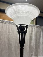 Frosted patterned glass torchiere shade atop metal support