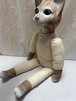 Front left view of cloth cat doll seated