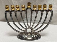 Front view showing full menorah, nine holders, Star of David base