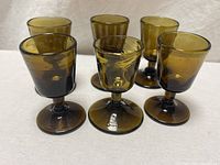 six smoky brown cordial glasses grouped