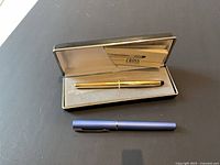 Two pens shown, Cross pen in case and Waterman pen below