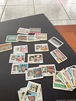 Overview of assorted manager and team photo cards spread on table